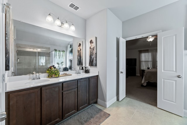 623 Woodridge Dr, Oak Point, TX 75068 - ensuite bathroom with a stall shower, tile patterned floors, double vanity, ceiling fan, and baseboards