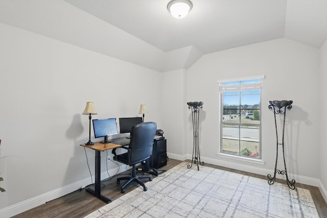 office space featuring baseboards, lofted ceiling, and wood finished floors