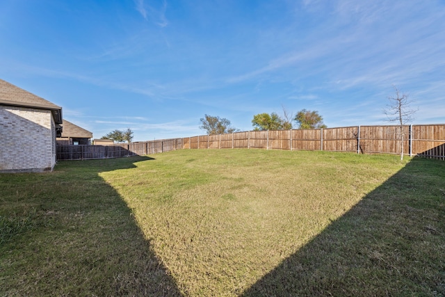 view of yard with a fenced backyard