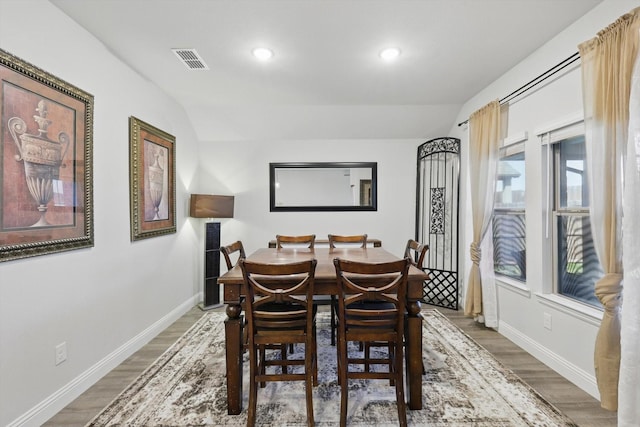 dining space featuring visible vents, baseboards, and wood finished floors