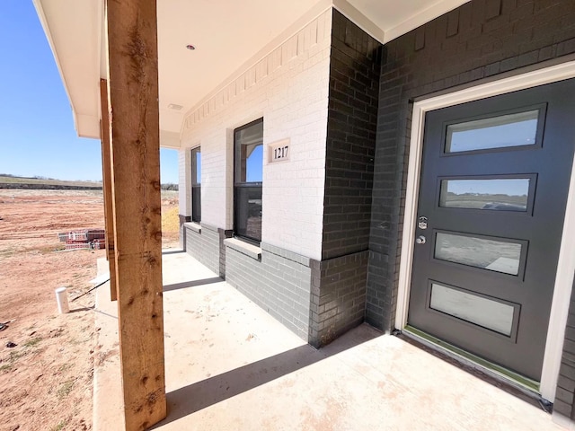 entrance to property with brick siding