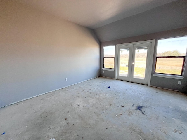 empty room with french doors and lofted ceiling