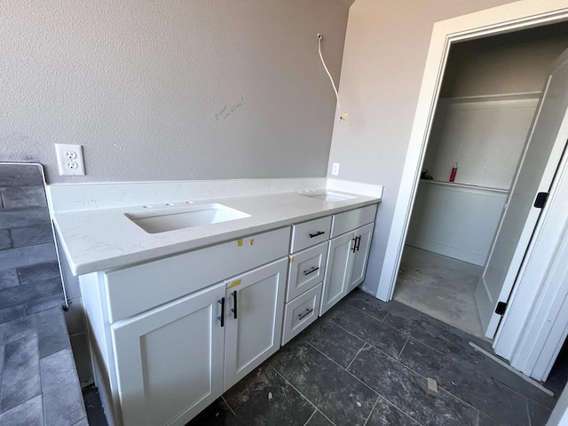 bathroom featuring a sink and double vanity