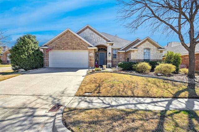 view of front facade with brick siding, stone siding, driveway, and an attached garage