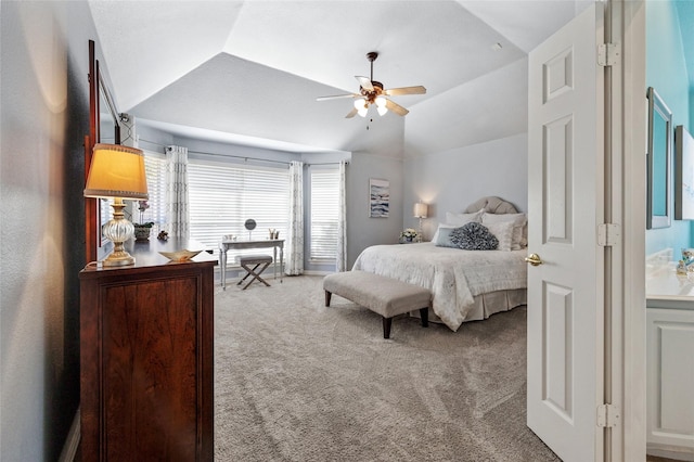 carpeted bedroom featuring lofted ceiling and a ceiling fan