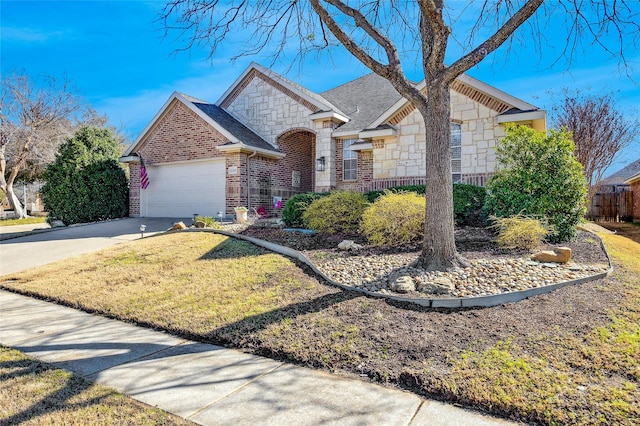 view of front of property featuring stone siding, roof with shingles, concrete driveway, an attached garage, and brick siding