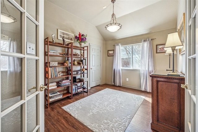 interior space featuring lofted ceiling, french doors, dark wood-type flooring, and baseboards