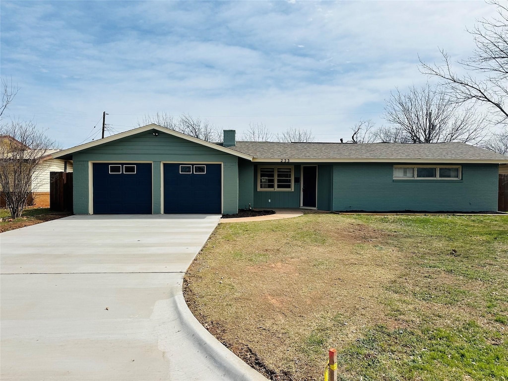 ranch-style house with a front lawn, an attached garage, and driveway