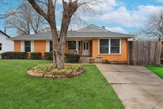 view of front of house featuring a front yard, fence, and brick siding