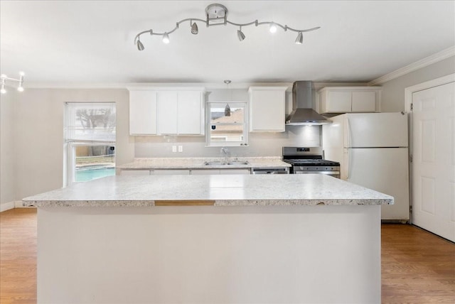 3105 Marydale Rd, Garland, TX 75041 - kitchen featuring a sink, a kitchen island, stainless steel appliances, light wood-style floors, and wall chimney range hood