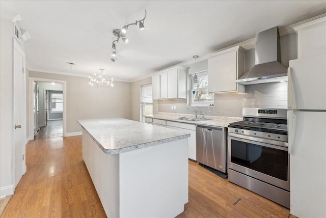 3105 Marydale Rd, Garland, TX 75041 - kitchen with a center island, wall chimney range hood, light countertops, appliances with stainless steel finishes, and a sink