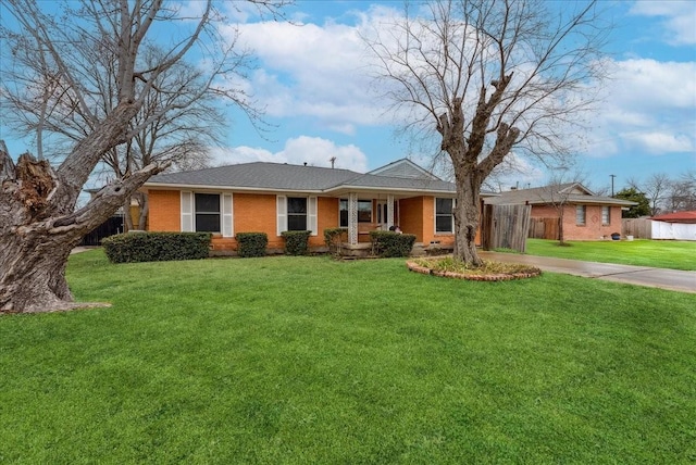 ranch-style home with brick siding, a front yard, and fence