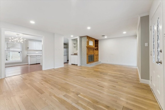 3105 Marydale Rd, Garland, TX 75041 - unfurnished living room with baseboards, recessed lighting, light wood-style flooring, a fireplace, and a notable chandelier