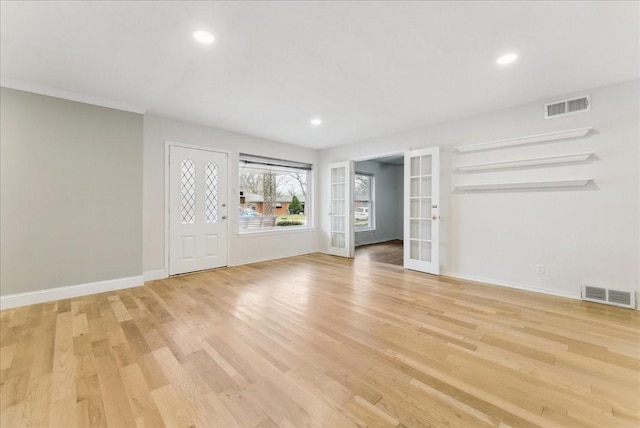 3105 Marydale Rd, Garland, TX 75041 - unfurnished living room with french doors, baseboards, light wood-style floors, and visible vents