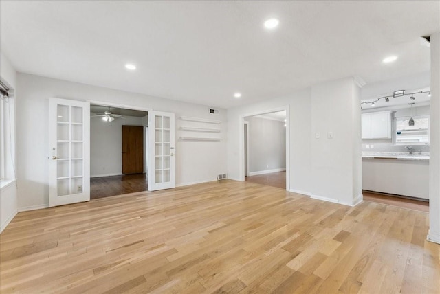 3105 Marydale Rd, Garland, TX 75041 - unfurnished living room featuring recessed lighting, french doors, light wood-type flooring, and a sink
