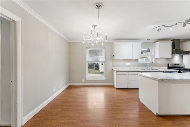 3105 Marydale Rd, Garland, TX 75041 - kitchen featuring light countertops, light wood-style flooring, wall chimney exhaust hood, and stainless steel gas range
