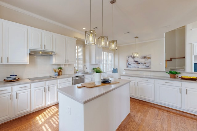 kitchen with under cabinet range hood, stainless steel dishwasher, backsplash, light wood finished floors, and black electric cooktop