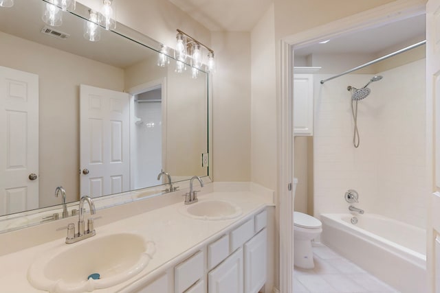 bathroom with a sink, visible vents, toilet, and double vanity