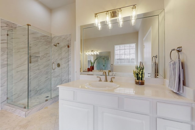 full bath with vanity and a marble finish shower