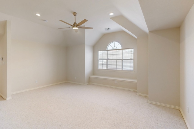 carpeted spare room featuring lofted ceiling, recessed lighting, baseboards, and visible vents