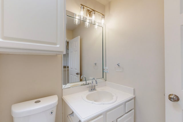 bathroom featuring toilet and vanity