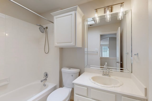 bathroom with toilet, vanity, and  shower combination