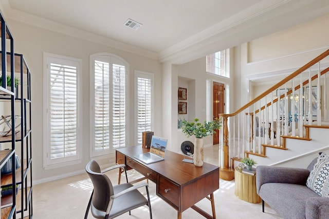 office area featuring plenty of natural light, carpet, visible vents, and ornamental molding