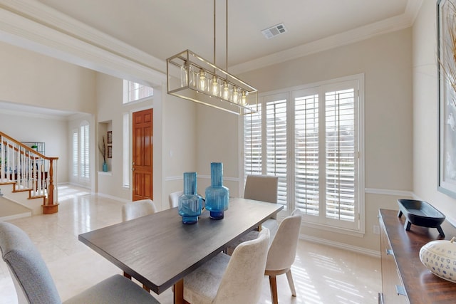 dining room featuring visible vents, stairs, baseboards, and ornamental molding