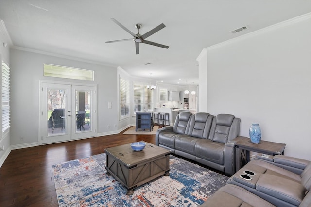 living room with wood finished floors, visible vents, baseboards, french doors, and crown molding