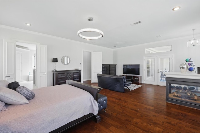 bedroom with visible vents, a multi sided fireplace, wood finished floors, and crown molding