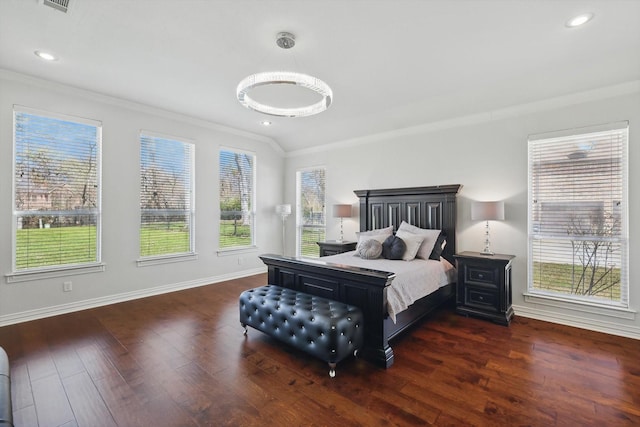 bedroom featuring baseboards, wood finished floors, and ornamental molding