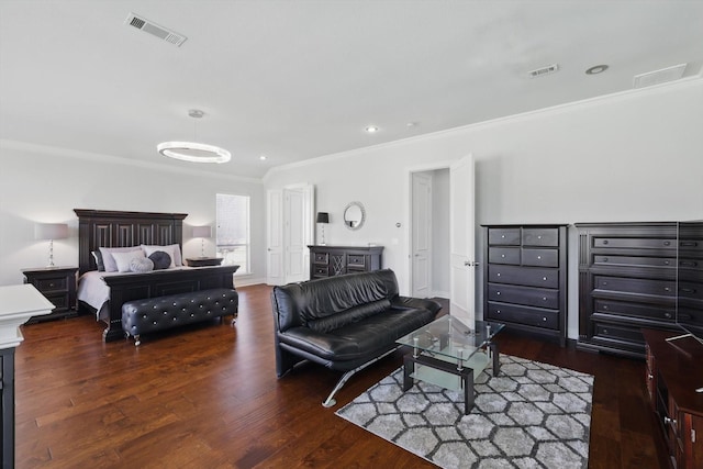 bedroom with visible vents, ornamental molding, baseboards, and wood finished floors