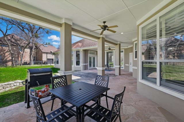 view of patio / terrace with outdoor dining space, french doors, a ceiling fan, and fence