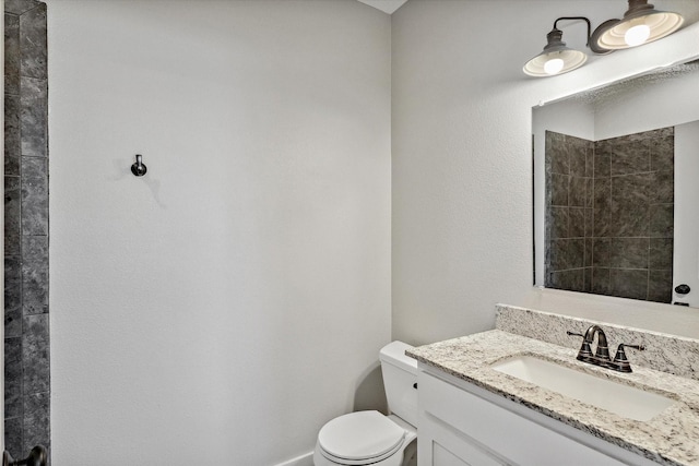 bathroom with toilet and vanity