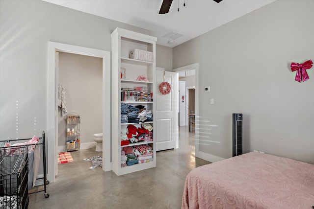 bedroom featuring ensuite bath, a ceiling fan, baseboards, and finished concrete floors