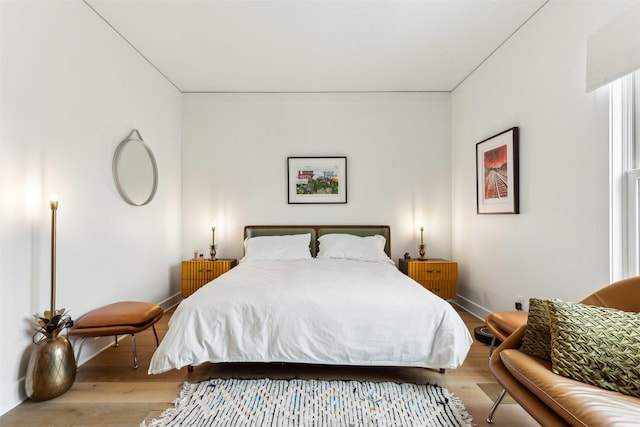 bedroom featuring baseboards and wood finished floors