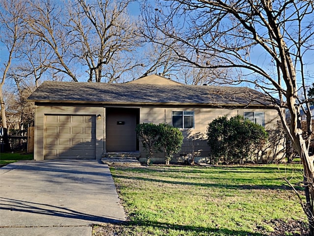 single story home featuring an attached garage, concrete driveway, and a front lawn