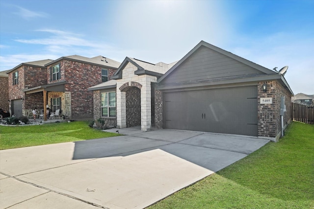 view of front of house featuring a front lawn, an attached garage, brick siding, and concrete driveway