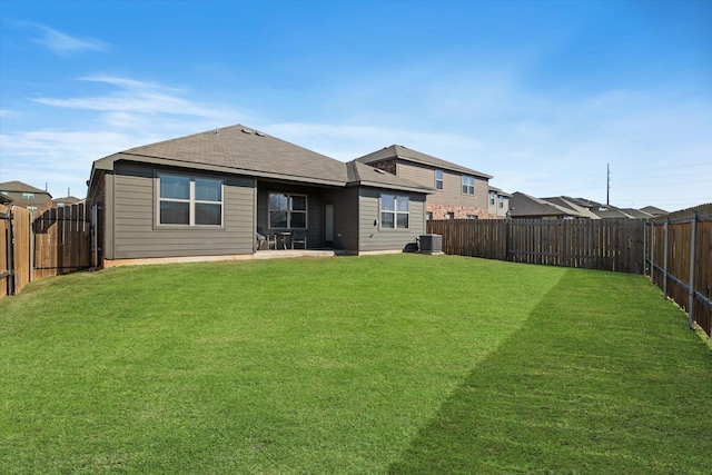 back of house featuring a fenced backyard, central AC unit, a patio, and a yard