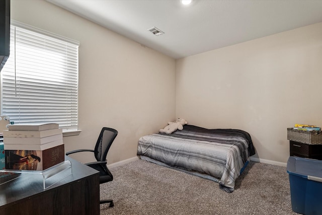 bedroom featuring baseboards, visible vents, and carpet floors