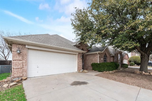 ranch-style house with a garage, brick siding, driveway, and a shingled roof