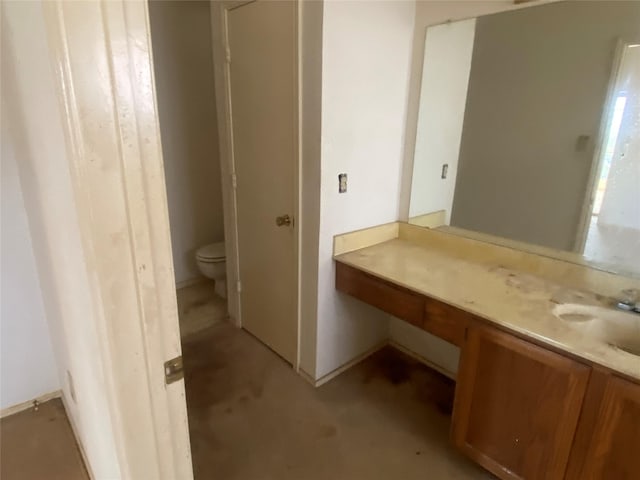 bathroom featuring vanity and toilet