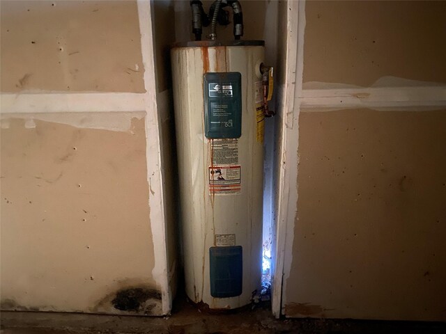 utility room featuring water heater