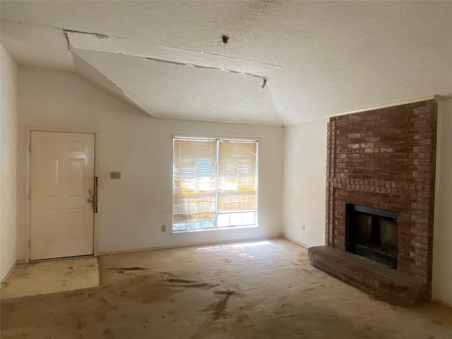 unfurnished living room featuring vaulted ceiling, a fireplace, and a textured ceiling