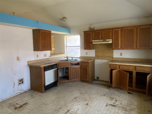 kitchen featuring under cabinet range hood, brown cabinets, dishwasher, and a sink