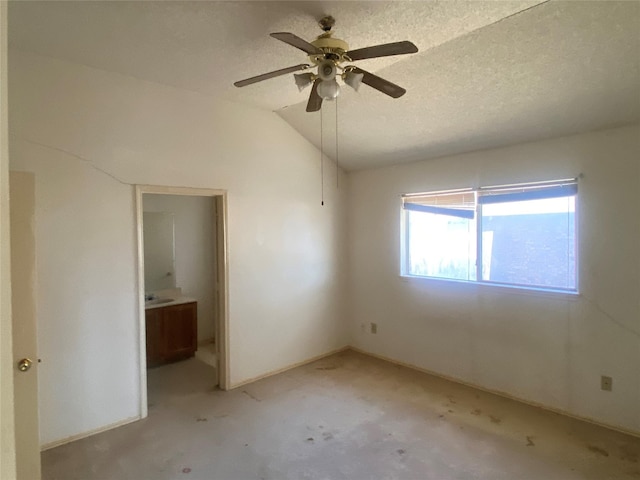 unfurnished bedroom featuring ensuite bath, lofted ceiling, a ceiling fan, and a textured ceiling