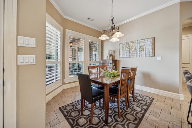 dining space with stone tile floors, baseboards, visible vents, arched walkways, and crown molding