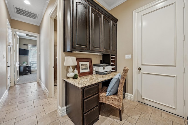 office space featuring ornamental molding, baseboards, visible vents, and built in study area