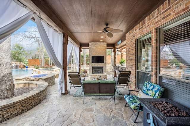 view of patio with fence, a ceiling fan, an in ground hot tub, an outdoor pool, and a large fireplace