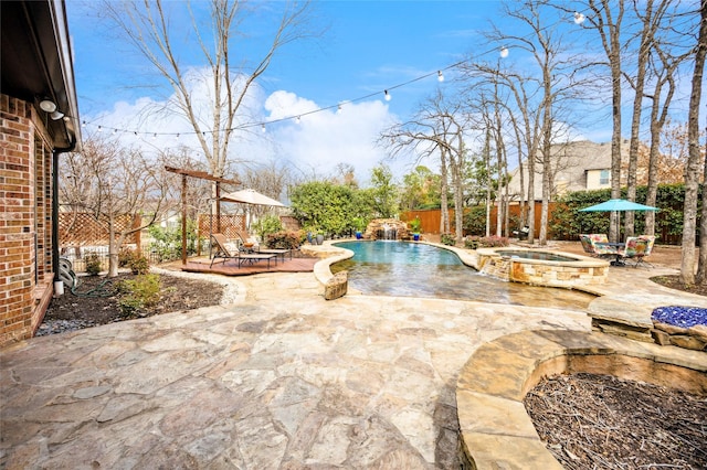 view of swimming pool featuring an in ground hot tub, a fenced in pool, a fenced backyard, and a patio